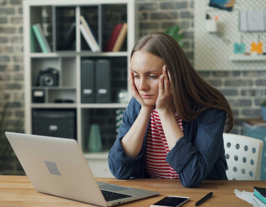 Woman sitting at desk stressed illustrating what happens when you ignore IRS notices