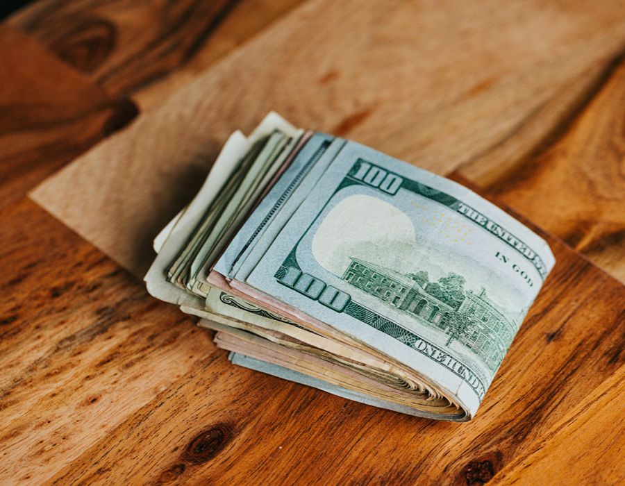 Wad of cash representing money taken through an IRS wage garnishment.