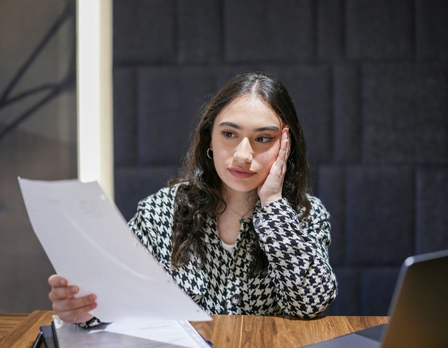 Business owner reviewing IRS trust fund recovery penalty notice for unpaid payroll taxes